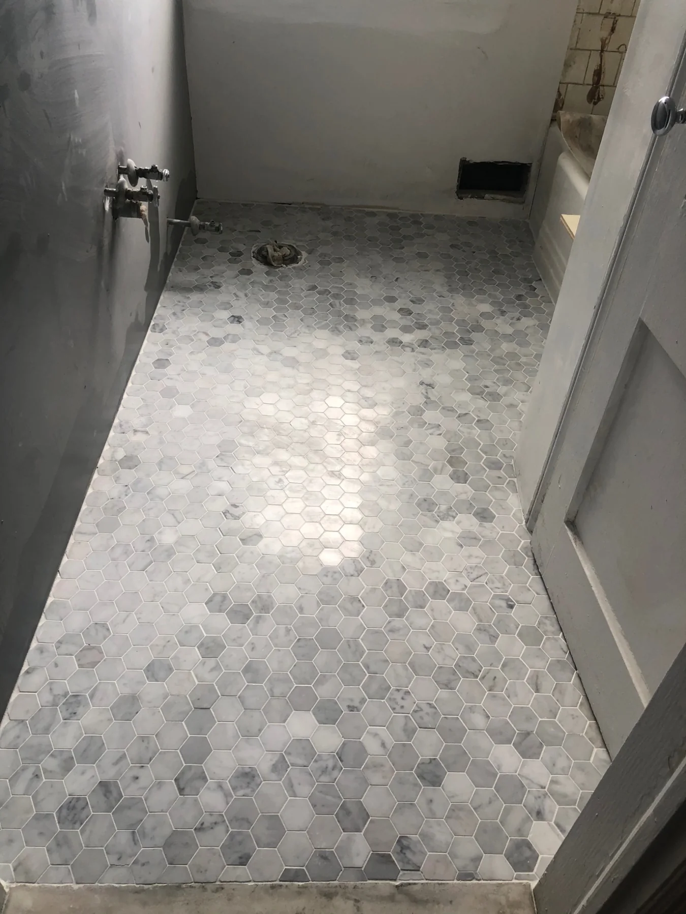 Detailed bathroom hex tile floor installation