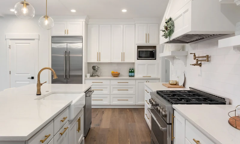 White kitchen remodel with gold hardware and island